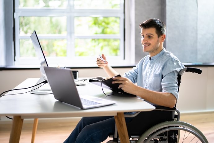 A man in a wheelchair studying